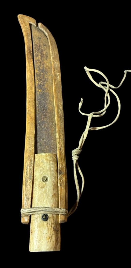 Eskimo/Inuit Knife and Wooden Sheath: Eskimo/Inuit knife with iron blade, bone handle and wood sheath. Sheath has leather binding at top to hold knife tight in sheath. Knife in sheath measures 13.5". Domestic shipping $16.