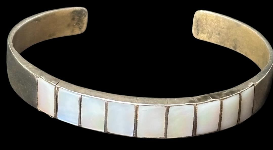 Native American Sterling and Mother of Pearl Cuff Bracelet: Native American sterling and Mother of Pearl inlaid cuff bracelet. Tested sterling, unsigned. Circumference with 1" cuff opening measures 7". Domestic shipping $8.
