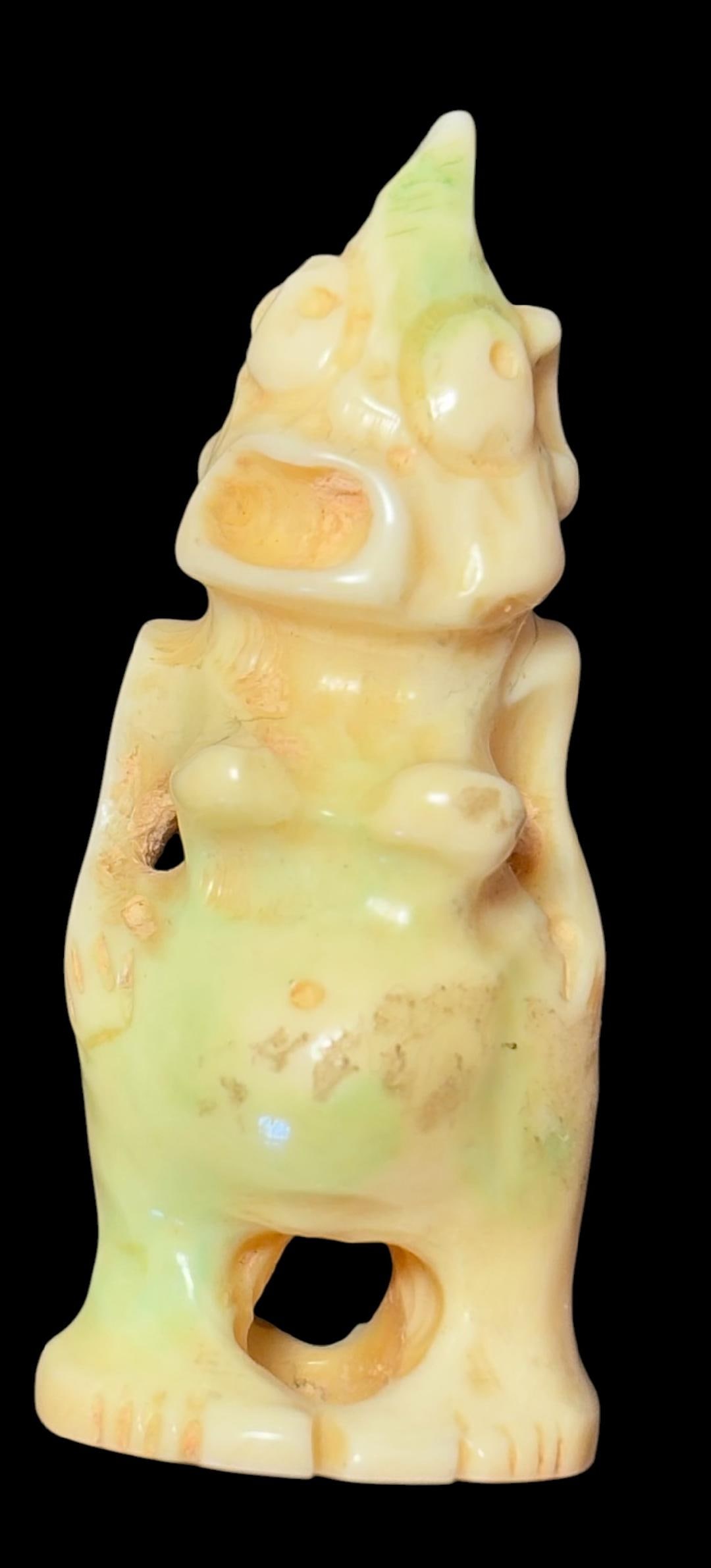 Bilikin Style Deity Carved Bone and Painted Pendant: Fertility looking fetish with grotesque face, pronounced buttocks and breasts. Carved bone 1.5" Antique piece. Domestic shipping $8