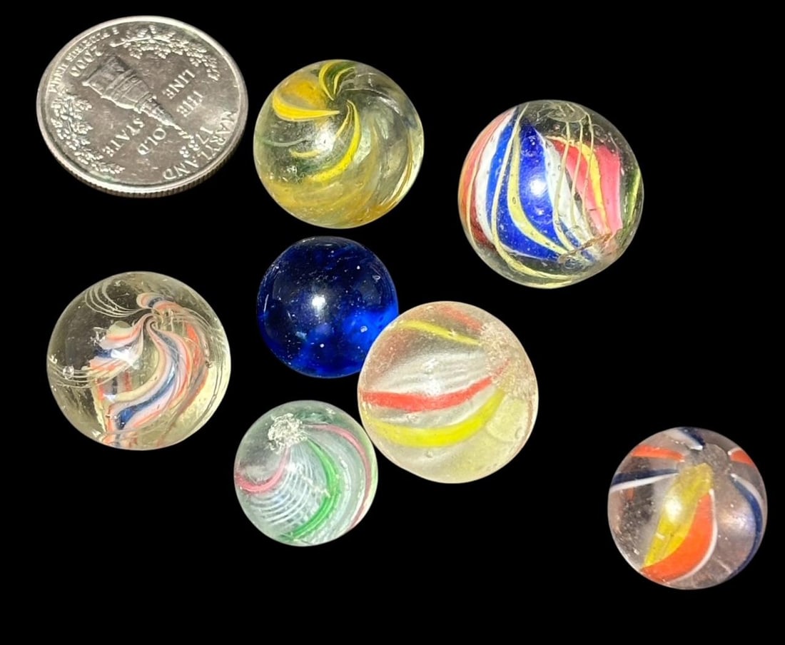 Lot of Seven Antique Swirl Marbles: Antique lot of seven swirl marbles. Quarter shown for size. Domestic shipping $8