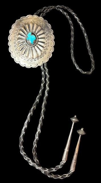 Vintage Native American Navajo Sterling and Turquoise Bolo Tie Signed TG: Vintage Native American Navajo sterling and turquoise bolo tie. Signed TG and marked sterling. Bolo tie measures 38" with sterling tips. Bolo measures 2.75" x 3.25" and is the older type of bennet cla