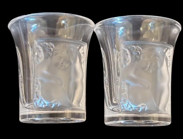 Pair of Lalique "Enfants" Shot Glasses: Pair of Lalique shot glasses in the frosted "Enfants" style. Measures 1.5" tall. For in-house shipping, select "bidder arranged". Domestic shipping $12.