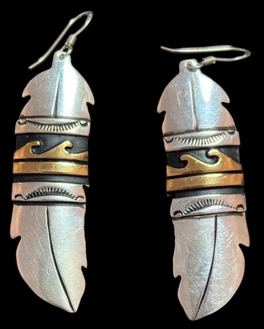 Native American Navajo Signed Tommy and Rosita Singer Sterling Pierced Earrings: Native American Navajo signed sterling and gold tone feather earrings. Signed T & R Singer. Measures .5" x 2". For in-house shipping, select "bidder arranged". Domestic shipping $8.