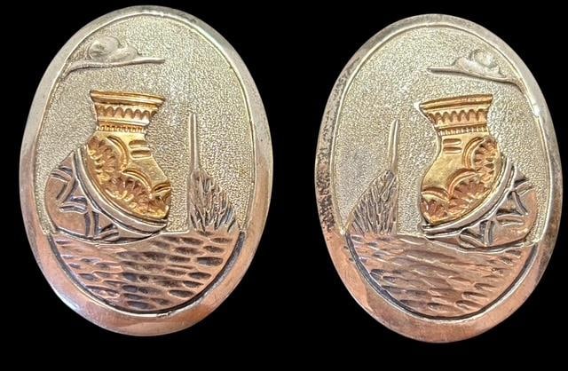 Native American Sterling and Goldtone Olla Design Oval Earrings Signed WAT: Native American oval earrings in sterling and goldtone. Olla pot shaped. Signed WAT and marked sterling. Measures 1.5" x 1".
