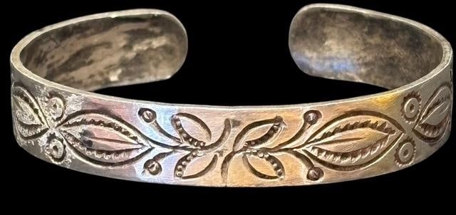 Native American Sterling Stamped Cuff Bracelet: Native American sterling cuff bracelet with a nice, stamped design. Measures 7" around with a .5" cuff opening. Weighs 16.5 g.