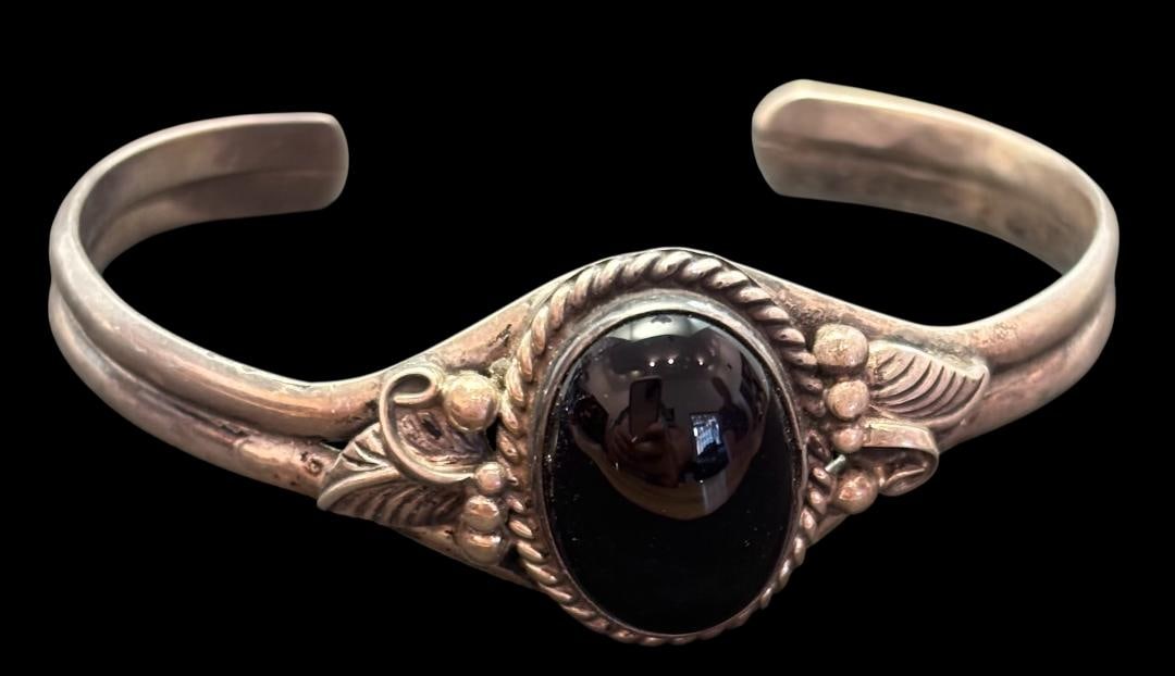 Sterling and Onyx Cuff Bracelet: Sterling and onyx cuff bracelet. Measures 6" with a 1" cuff opening.