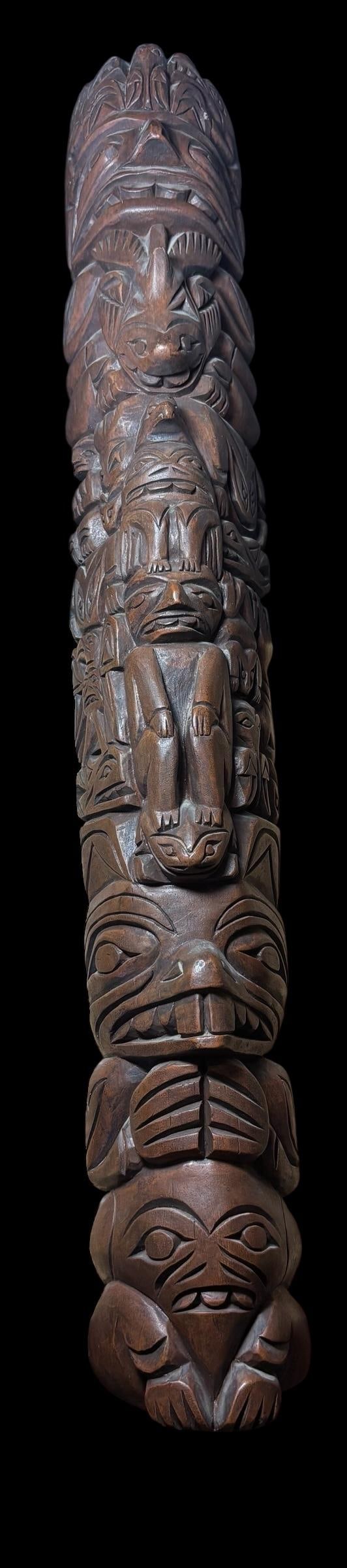 Vintage 1973 Philip Thorn Strongman Tlingit Totem Pole: Carved wood totem pole original 1973 signed Philip Thorn with original trading post label. Strongman totem pole with whale, eagle, frog and beaver, from Tlingit Indian Tribe. 22" x 3.5" x 3.75"