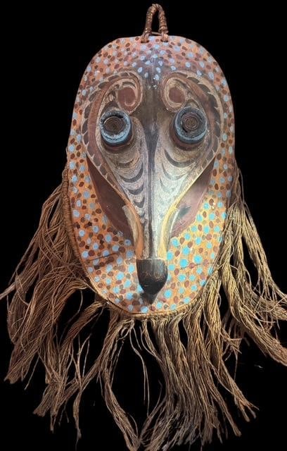 Antique Sepik River, Papua New Guinea Tribal Mask: Sepik River Papua New Guinea tribal mask. Carved from single piece of wood with coiled eyes and hand carved and painted bird nose. With twine faux hair mask measures 23". Wood part of mask measures 9.