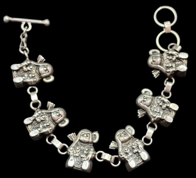 Native American Navajo Storyteller Bracelet Signed GS: Native American Navajo storyteller bracelet with six storyteller figures. Signed G.S. and marked sterling. Measures 7". Weight 34.8 grams.