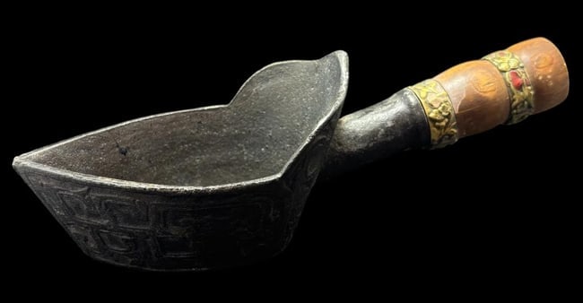 Antique Chinese Silk Iron: Antique cast iron silk iron. Decorated with brass rings on the wooden handle. Measures 7.75" x 2.25".