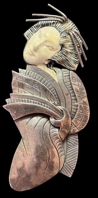 Hand Carved Sterling and Mammoth Bone Zealandia Brooch/Pendant: Hand carved sterling and mammoth bone brooch/pendant. Carved Geisha Face. Copyright Zealandia. Marked .925. Measures 2.5" x 1".