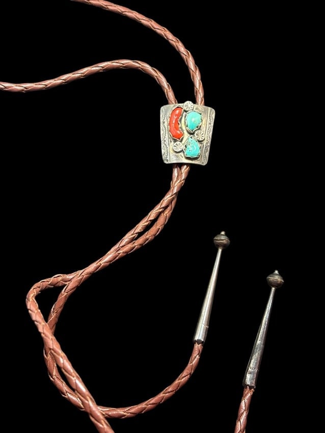 Native American Navajo Sterling, Turquoise and Coral Bolo Tie: Native American Navajo bolo tie with coral and turquoise on a leather cord with sterling tips. Marked Bennett and pat. Pend. Bolo measures 1" x 1.25".