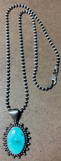 Native American Navajo Pendant Necklace Signed Peggy Skeets: Native American Navajo pendant necklace. Oval pendant has a turquoise stone and measures 1" x 1.75". Marked sterling and signed P Skeets (Peggy Skeets). Italian sterling chain measures 19".