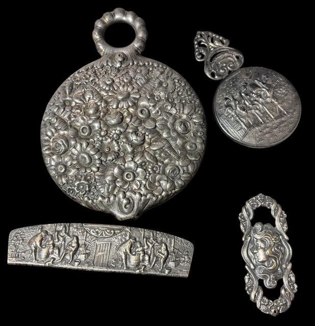 Lot of Four Antique Repoussé Ladies Silverplate Vanity Pieces: Lot of four lady's silverplate vanity pieces. 1) Heavy floral repousse hand mirror. Measures 7" x 5". 2) Comb - measures 1.5" x 5". All teeth intact. 3) Danish hand mirror. Measures 2.75" x 4.5". 4) A
