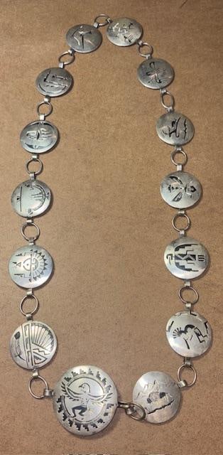 Native American Navajo Signed Sterling Concho Belt: Native American Navajo signed sterling concho belt. Hallmark signed by Navajo silversmith. See photos. Measures 36" and weighs 175g. Includes thirteen 1.5" round conchos with different design on each.
