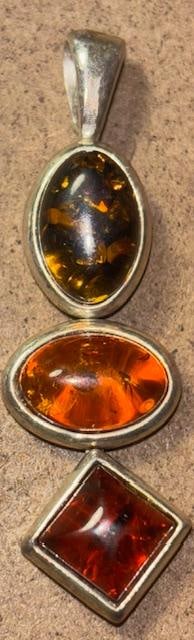 Sterling and Amber Stone Pendant: Sterling and amber three stone pendant. Measures .5" x 1.75".