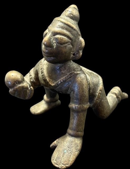 Antique Bala Krishna Figure Ca 1850: Antique brass/bronze Baby Bala Krishna figure holding a butterball. Measures 2" x 2.5".