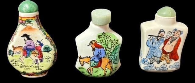 Lot of Three Signed Hand-Painted Porcelain Snuff Bottles: Lot of three porcelain painted snuff bottles with jade lids. Spoons intact. Two are signed. Measure 2" - 2.5".