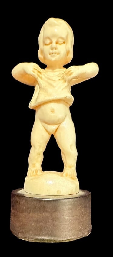 Carved Bone Boy on Pedestal: Carved bone figure of a small boy on a pedestal. Figure measures 2". Pedestal measures 2.5".