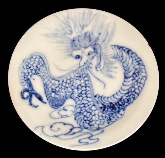 Blue and White Imari Style Dragon Decorative Plate: Blue and white Imari style decorative plate. Features dragon scene. Marked MGR on base. Measures 4" diameter.