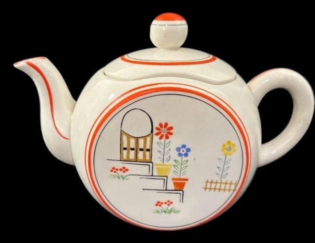 Mid-Century Japanese Tea Pot: Mid-century Japanese tea pot. Floral painted accents. Measures 7"tall and 10" wide from spout to handle.