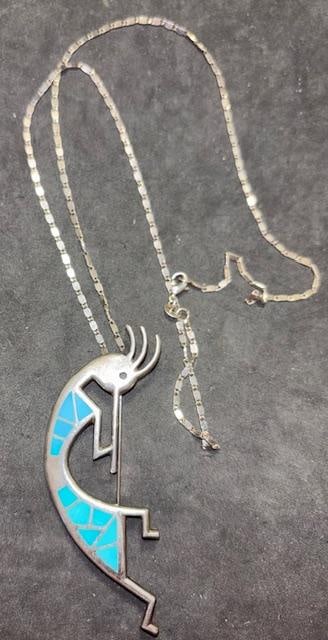 Sterling and Turquoised Kokopelli Pendant Necklace: Sterling and turquoise kokopelli pin/pendant necklace. Necklace measures 23" with a 1" x 3" pendant.