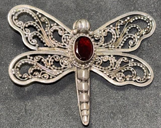 Sterling and Stone Butterfly Brooch: Sterling and red stone butterfly brooch. Marked .925. Total weight 6g. Measures 1.75" x 1.5". Unsigned.