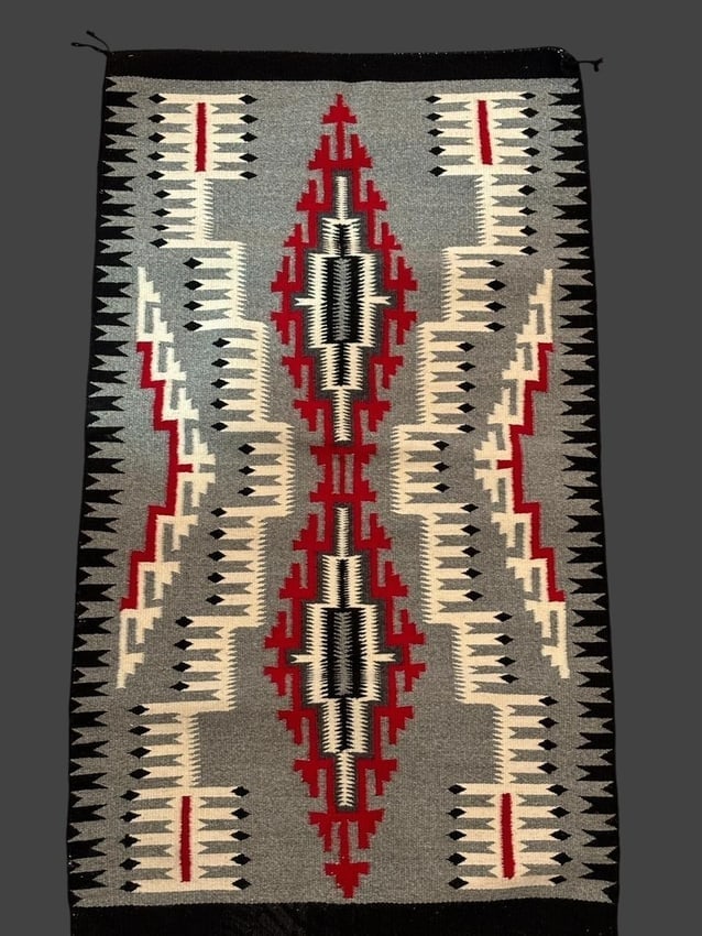 Mae Tso Storm Pattern Navajo Hand Woven Rug with COA: Navajo hand-woven rug. Woven by Mae Tso in the storm pattern and includes a COA. Measures 23" x 42".