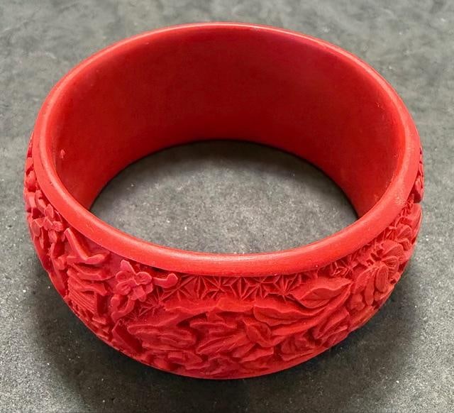 Chinese Red Cinnabar Bangle Bracelet: Chinese red cinnabar bangle bracelet. Circumference measures 7". Inside diameter measures 2.5".
