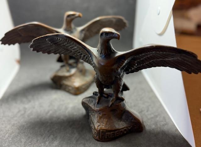 Pair of Bronze Eagle Bookends Signed Eugenie F 1917: Pair of bronze winged eagle bookends. Signed Eugenie F. Marked 1917 and World Freedom in rear tail feather section. Measures 9"x 3" x 6".