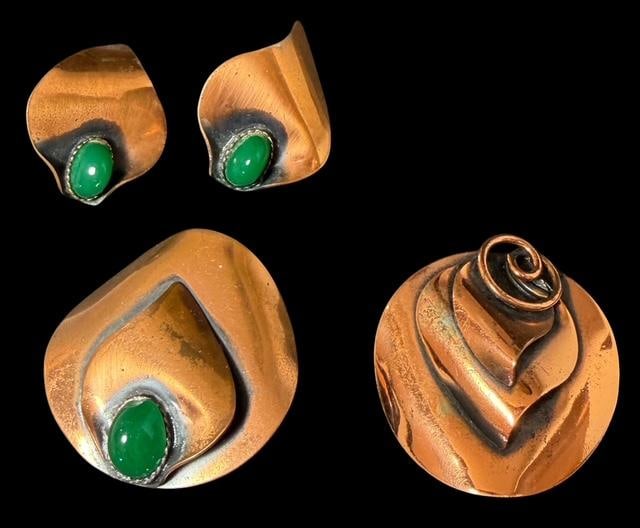 Mid Century Copper Stylized Pin/Pendant and Earrings: Mid Century stylized copper pin/pendants and clip earrings. Matching pin and earrings have green stones. Pendant one measures 2" x 2". Pendant two measures 1.75" x 1.75". Earrings measure 1.5" x 1". U