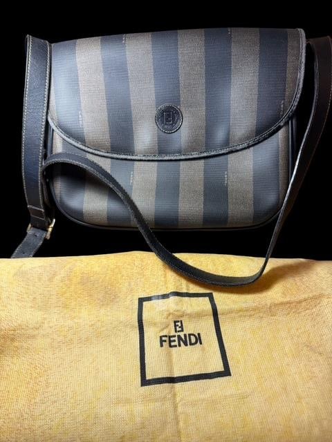 Fendi Cross Body Purse: Fendi crossbody canvas purse. Includes protective cloth bag for storage. Measures 12" wide by 9.5" tall, excluding strap.