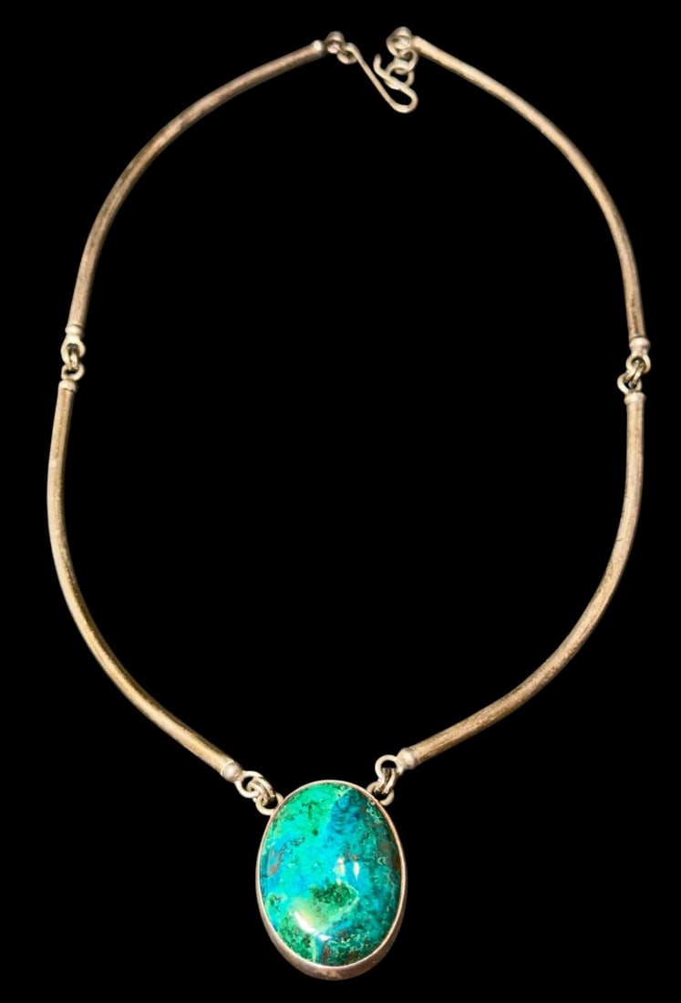 Sterling and Chrysocolla Pendant Necklace: Sterling and chrysocolla pendant necklace. Pendant marked .925 and measures 1" x 1.25". Weighs 28g. Necklace measures 15" in a four-section design.