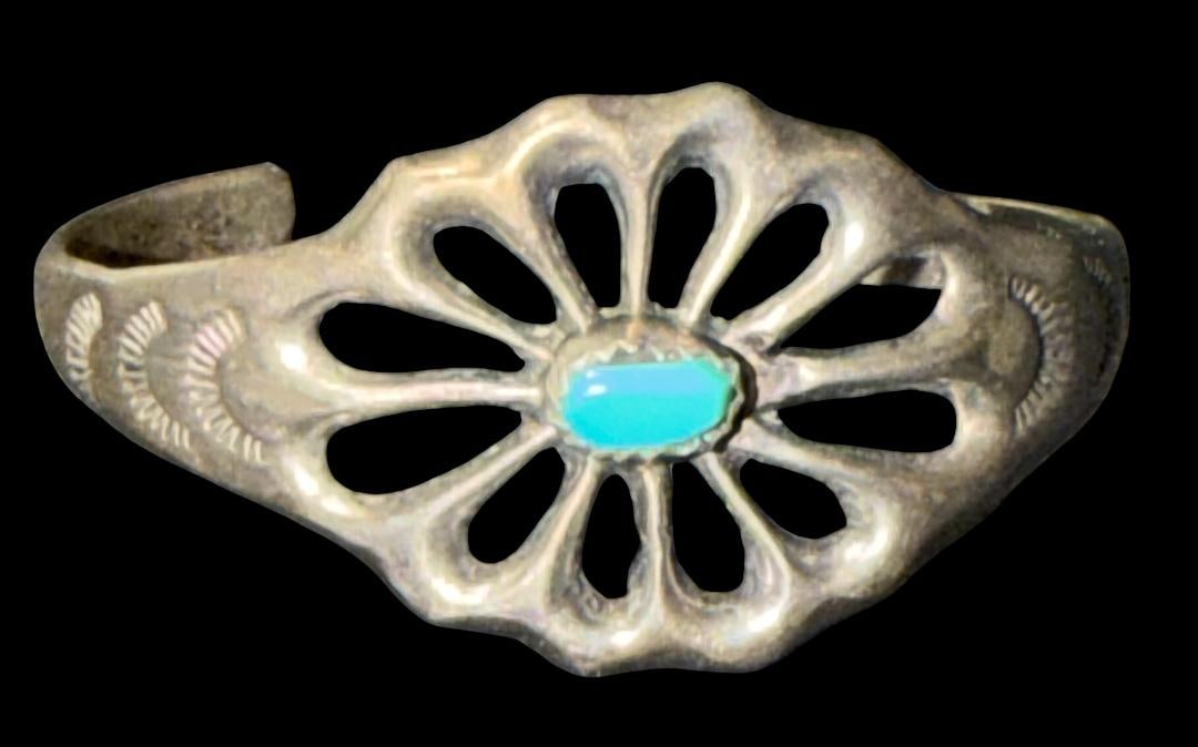 Native American Navajo Sterling and Turquoise Childs' Cuff Bracelet: Native American sterling and turquoise cuff bracelet. Child's size. Sandcast. Weighs 11 g. Measures 5" around with a 1" cuff opening.