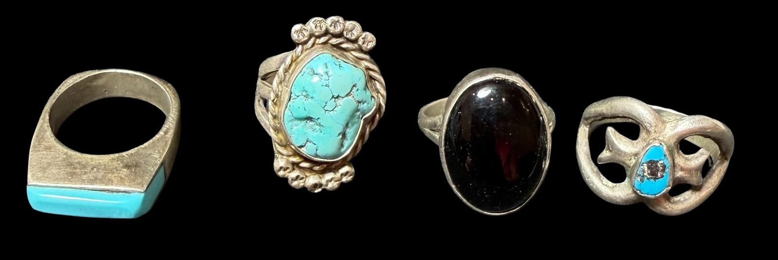 Lot of Four Native American Sterling and Stone Rings: Lot of four Native American sterling and stone rings. 1) Sandcast with center turquoise center stone. Tested sterling, unsigned. Size 9. 2) Tested sterling with center turquoise stone. Hallmark signed