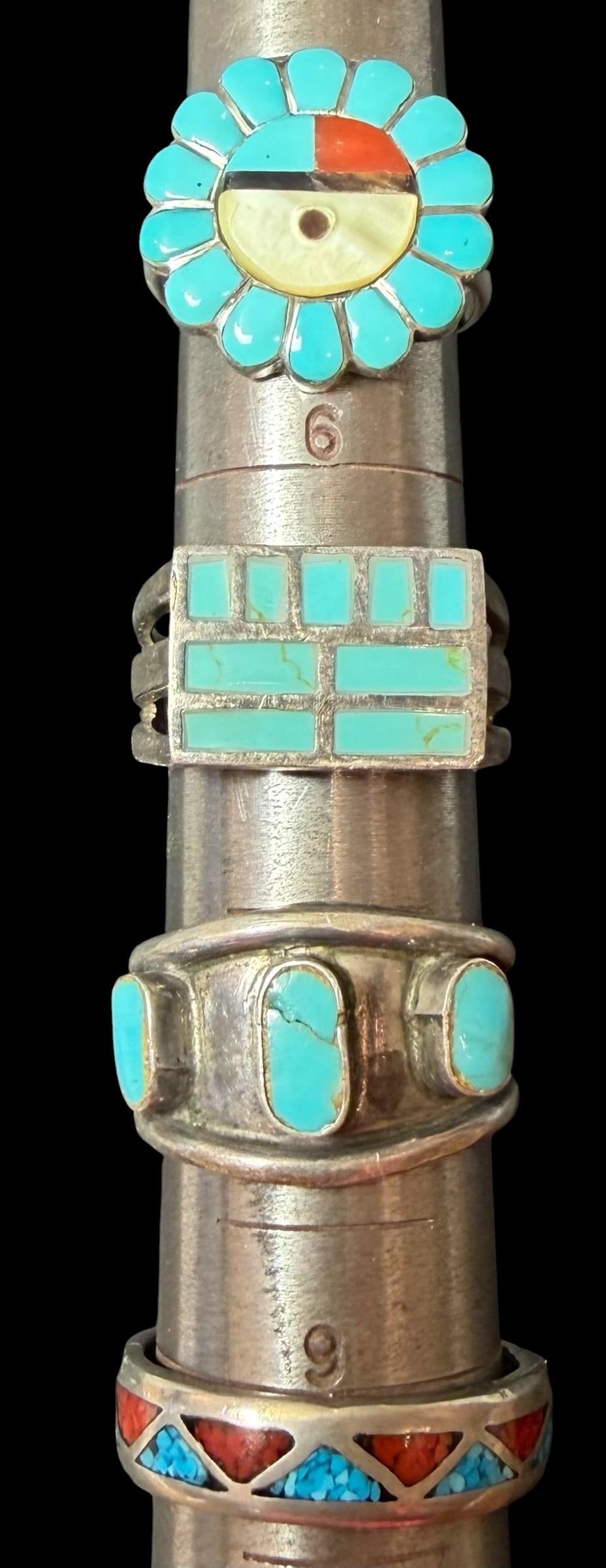 Lot of Four Native American Sterling and Stone Rings: Lot of four Native American sterling and stone rings. 1) Band inlaid with coral and turquoise. Size 10. Unsigned. 2) Zuni sunface design. Size 6. Unsigned. 3) Rectangular shape with inlaid turquoise. 