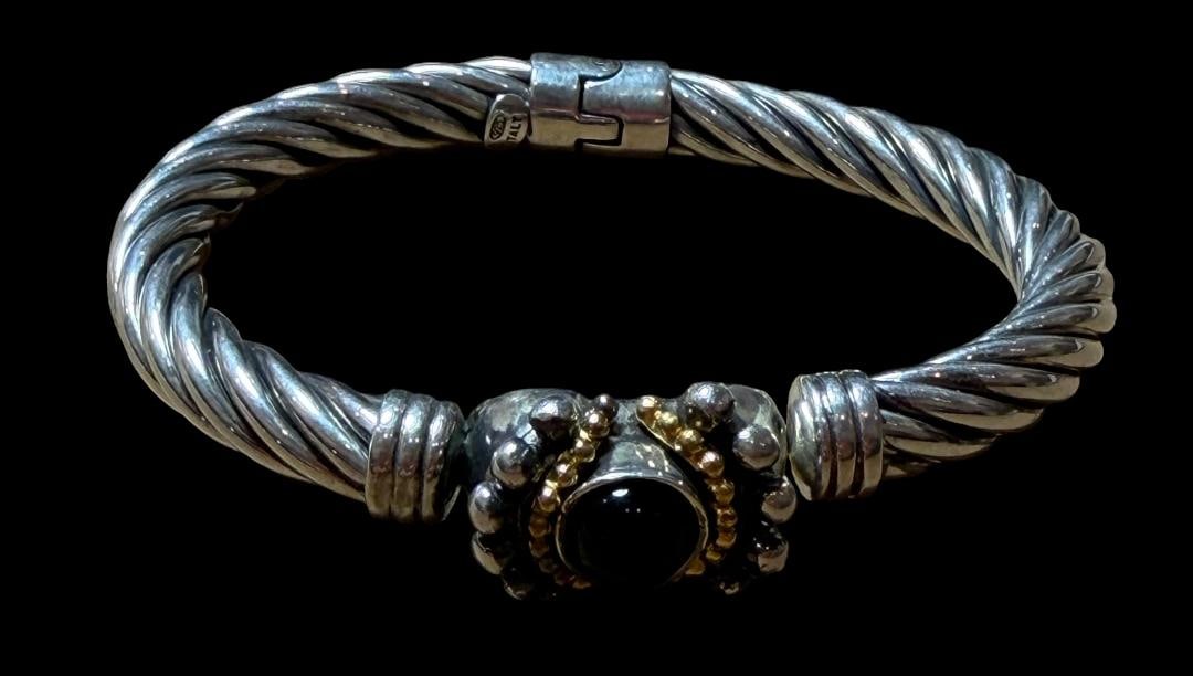 Italian Sterling and Stone Bracelet: Italian sterling and stone bracelet. Marked .925 and Italy. Purple center stone surrounded by goldtone and silvertone beads. Total weight 29g. Measures 2.5" diameter and 6.5" around.