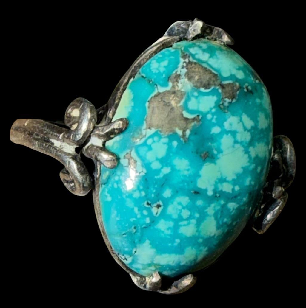 Native American Navajo Sterling and Turquoise Ring: Native American sterling (tested) and stone adjustable ring. Size now is 4.5. Total weight is 4.5g. Stone measures .5" x .75".