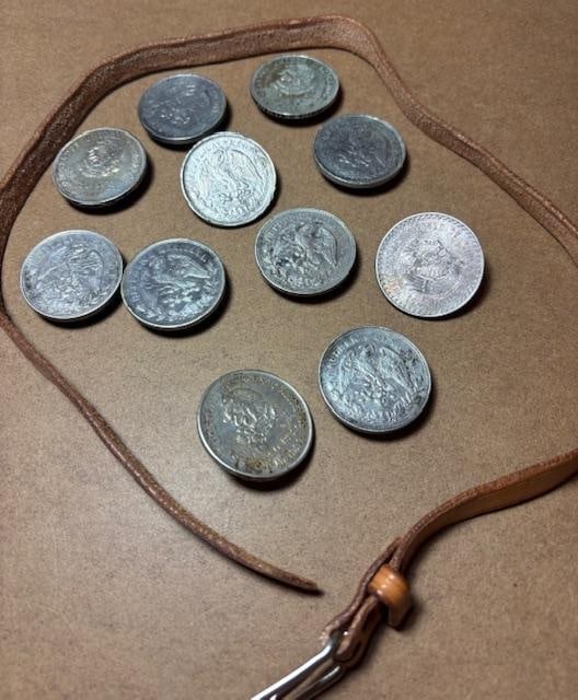 Vintage Leather Belt with Mexican Peso Applique: Vintage leather belt decorated with eleven vintage Silver Mexican Pesos. Pesos include 5 peso coins with the dates of 1952, 1957, 1948 and 1953. One peso coins include, 1904, 4-1902, 1899 and 1903. Ea