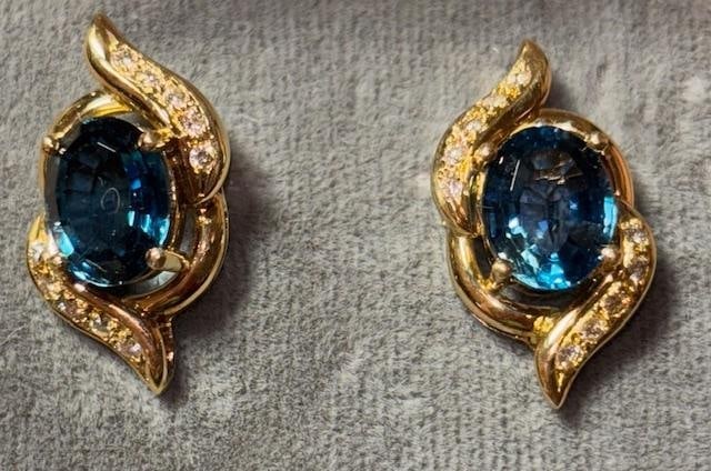 14k Gold and Blue Topaz Pierced Earrings: 14k gold earrings with a blue topaz stone. Weighs 6g and measures .25" x .75".