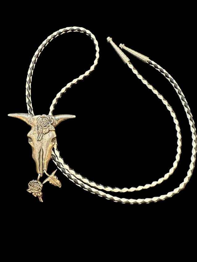 Sterling Steer Head with Rose Design Gal's Bolo Tie Cowgirl Signed AS: Sterling silver steer head bolo tie. Bolo is signed AS and marked sterling silver and measures 2.25" x 3.5". Attached to a black and white cord with non-silver tips that measures 32". Bolo has been