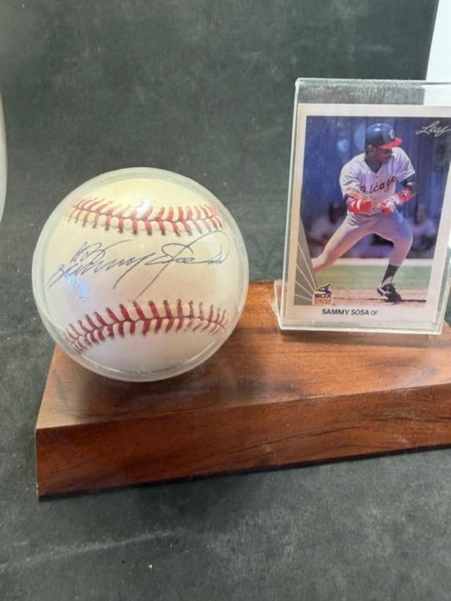Sammy Sosa Autographed Baseball and Baseball Card: Sammy Sosa autographed Rawlings baseball and upper deck baseball card. No COA and card unsigned and ungraded. Sosa played for the Chicago White Sox and was a Hall of Fame player. Measures 7" x 3.75" x