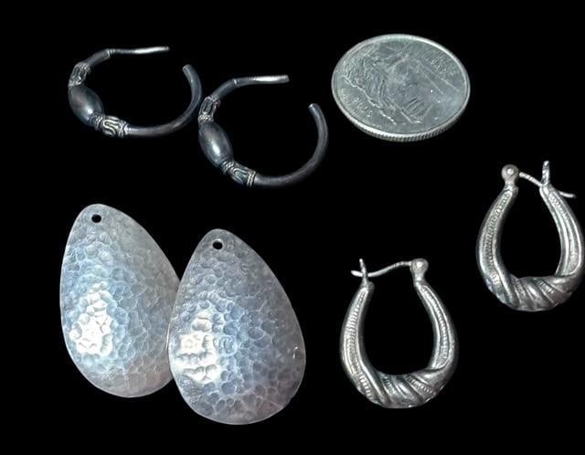 Lot of Three American Sterling Earrings: Lot of three American pairs of earrings. 1) Hammered teardrop shape. Marked JAW. Other two sterling hoop shaped. Quarter for size.