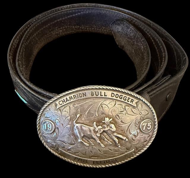 Native American Leather, Turquoise and Bead Belt with Sterling Belt Buckle: Native American leather belt with turquoise and bead accents and sterling, belt buckle. Buckle measures 4"x2.75". Marked Champion Bull Dogger, Phil Elliott, 1975. Also marked Wilson Silver Co, sterlin