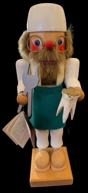 West Germany Holzkunst Christian Ulbrich Nutcracker: West German Holzkunst Christian Ulbrich nutcracker, depicting a dentist. Stamped on base and hang tag. Measures 11" tall. Base measures 3" x 3".