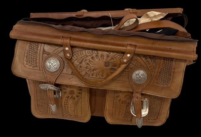 American West Tooled Leather Travel Luggage Handcrafted by Carlos: American West tooled leather travel luggage. Duffel/business attaché case. Never used. Measures 20" x 15" x 13". Hardware is brass and sterling and dated 2/98.