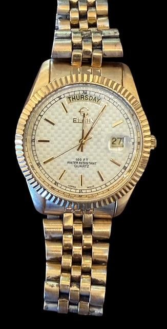 Elgin President Men's Watch: Elgin President men's watch. Quartz, 100 ft water resistant, fluted bezel. Stainless steel back. Measures 8" around.
