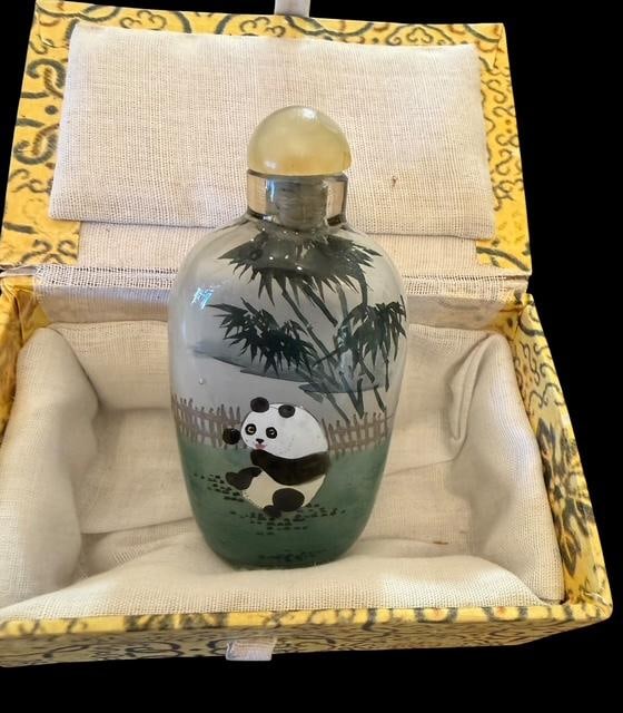 Reverse Painted Glass Snuff Bottle: Reverse painted glass snuff bottle. Panda bear design. Lid and cork intact, no spoon. Measures 3.25" x 1.5".