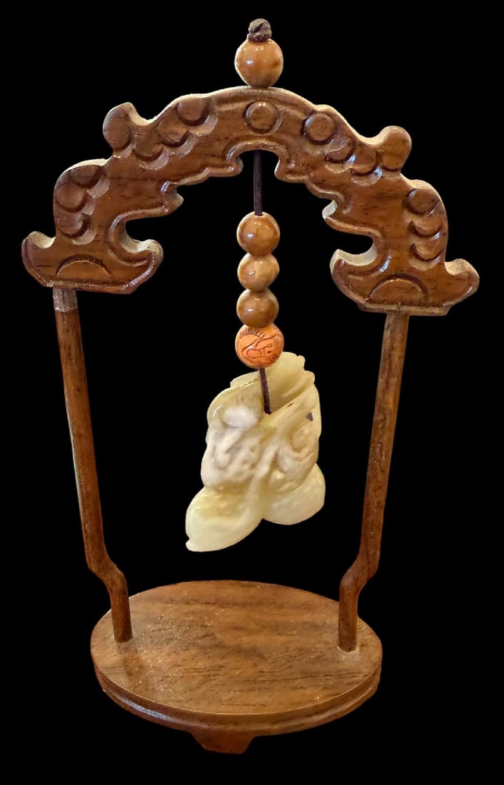 19th Century Chinese Carved Wood Display Stand with Jade Pendant: 19th century Chinese carved wood display stand with a Hetian jade pendant. Measures 6" tall by 3.5" tall. Pendant measures 1.5" x 1".