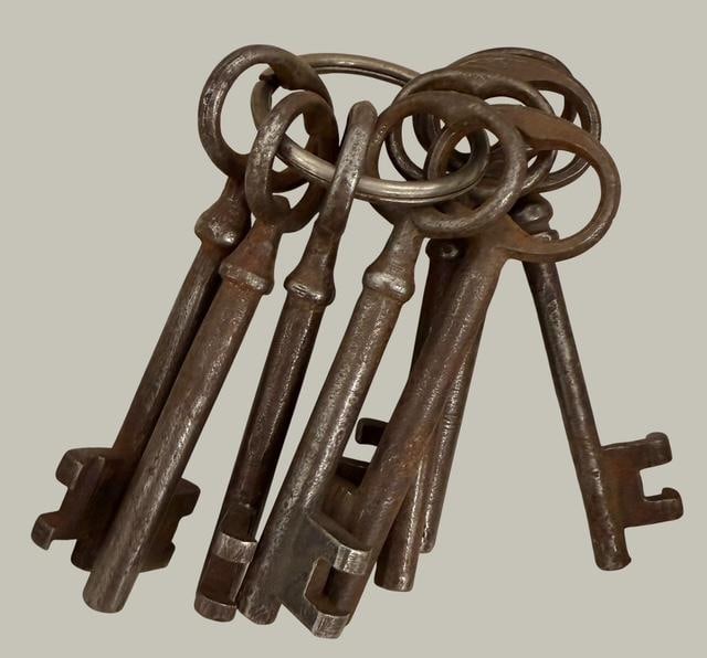 old west Eight Antique Steel Jailors/Skeleton Keys: Lot of eight steel jailers/skeleton keys. Each key measures 4" long by .75" wide.